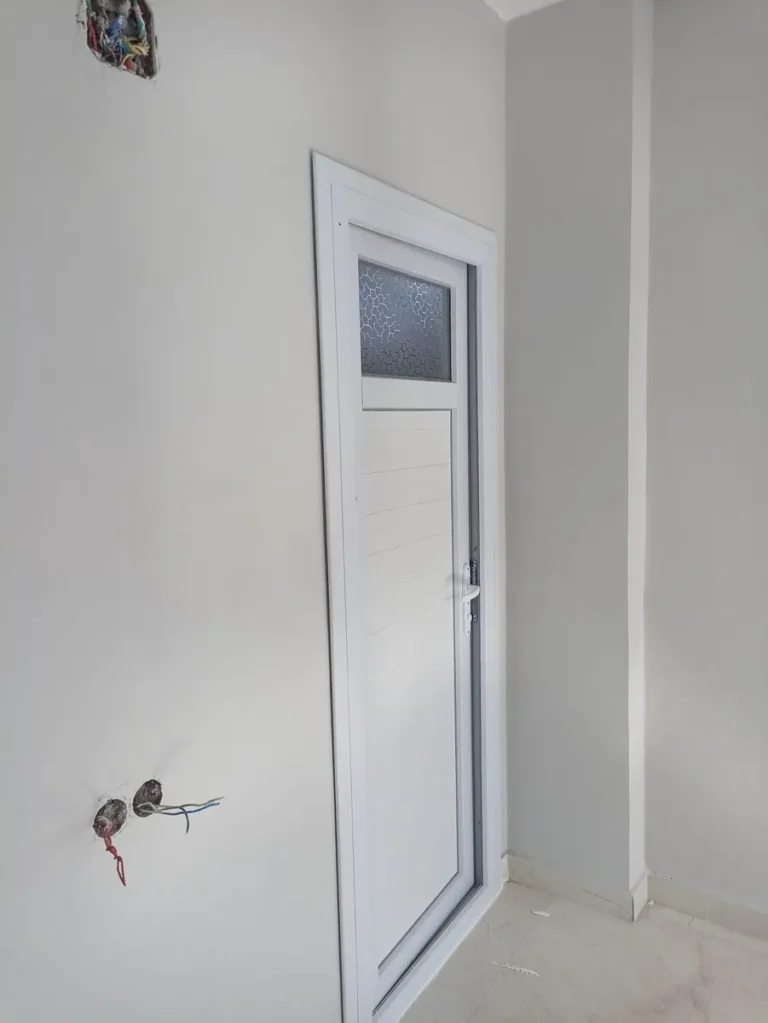 Yeni dairede üst kısmı buzlu cam panelli beyaz PVC kapı